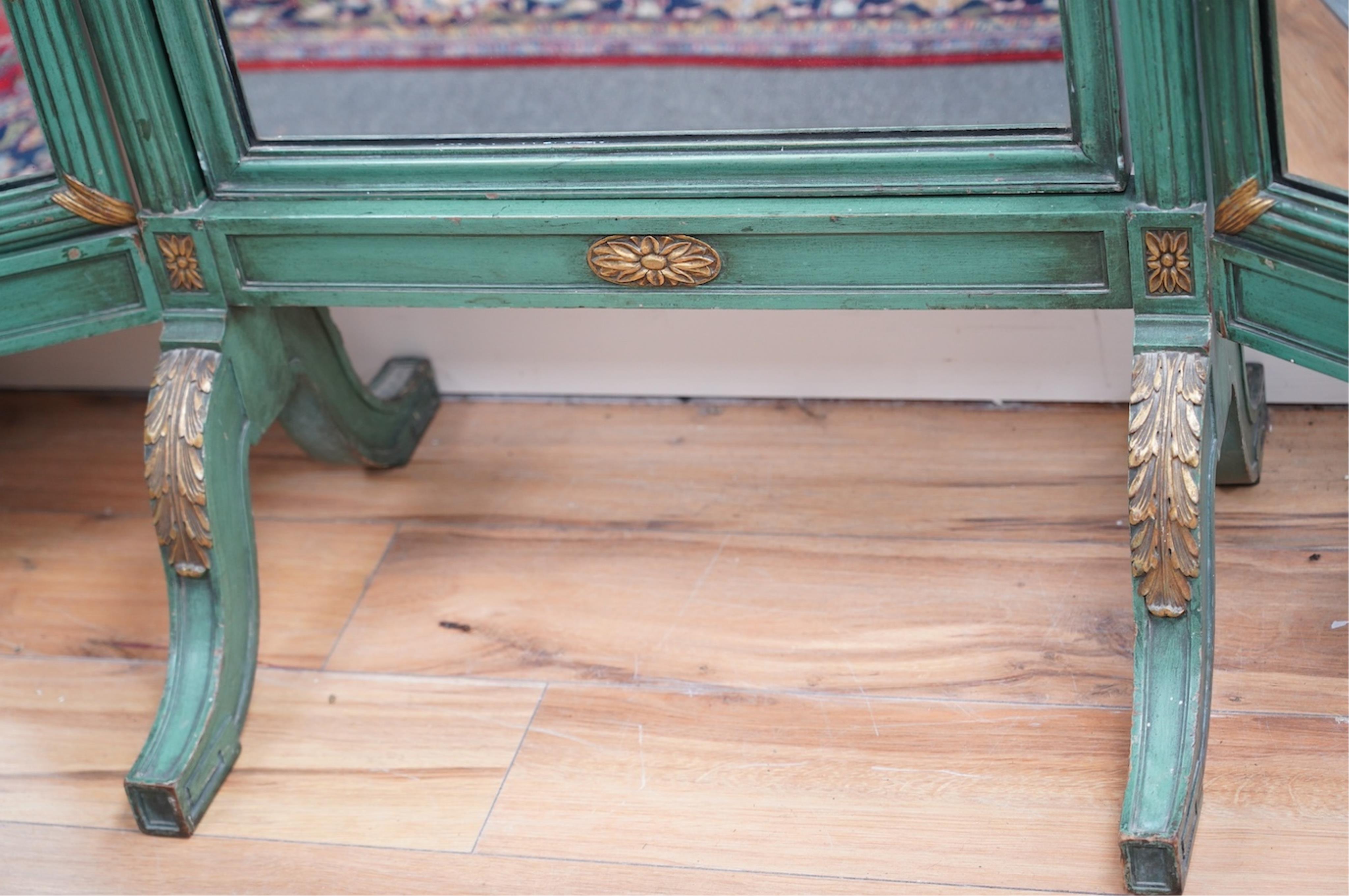A Louis XVI style green painted and parcel gilt triple folding dressing mirror, width 160cm, height 185cm. Condition - fair